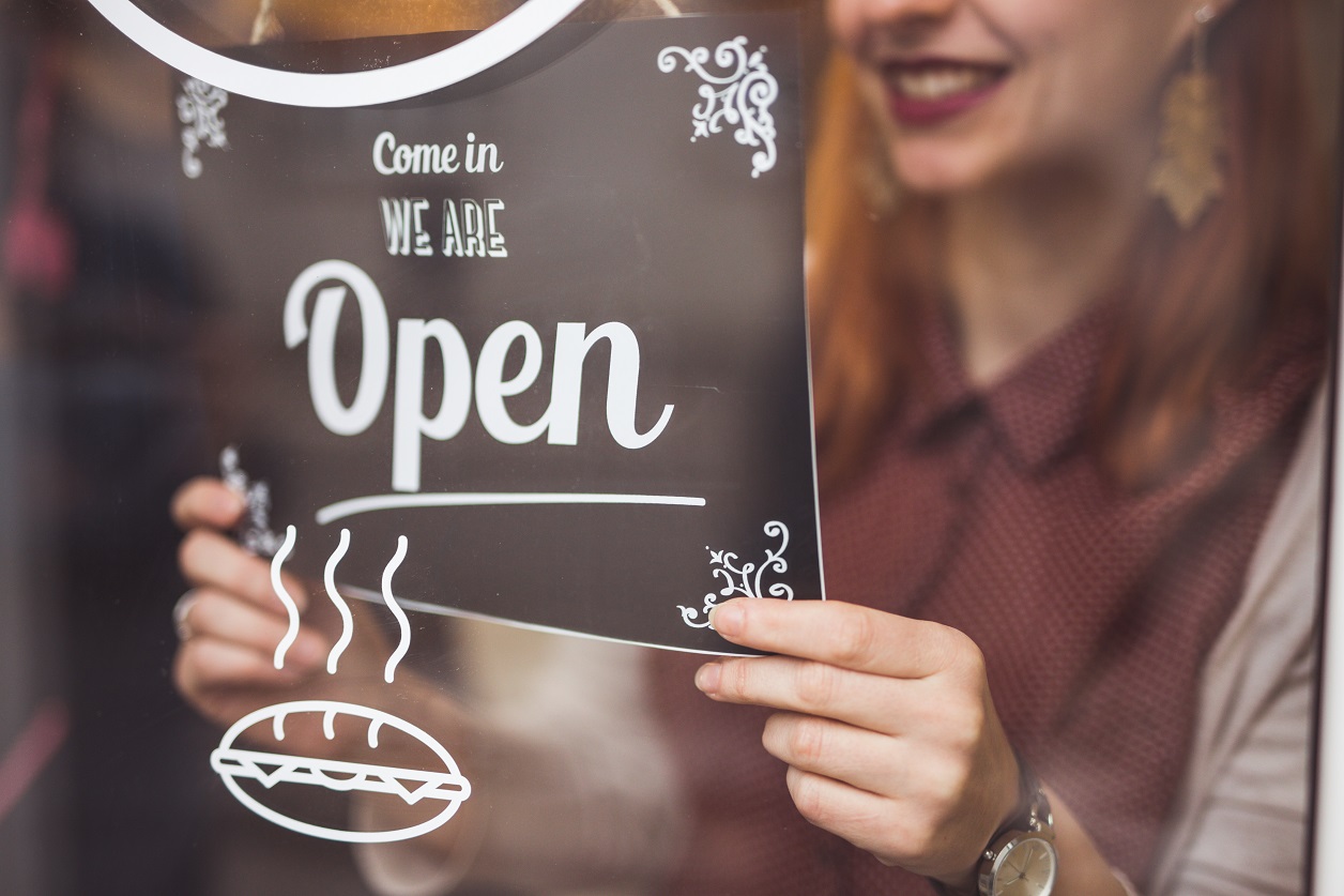 woman-setting-open-sign-small-business-owner-getty-908054780.jpg